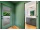 Hallway view into bathroom with stylish vanity and glass door leading to outdoor deck at 32 Walthall Ne St # A, Atlanta, GA 30307