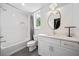 Bright bathroom with white subway tile, tub, and vanity with a modern oval mirror at 32 Walthall Ne St # A, Atlanta, GA 30307