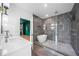Modern bathroom showcasing a standalone tub and spacious glass shower with gray stone tile at 32 Walthall Ne St # A, Atlanta, GA 30307