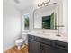 Contemporary bathroom featuring a sleek vanity, a large mirror, and a toilet at 32 Walthall Ne St # A, Atlanta, GA 30307