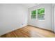 Bright bedroom featuring hardwood floors and a window view of lush greenery at 32 Walthall Ne St # A, Atlanta, GA 30307
