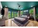 Spacious bedroom with hardwood floors, a ceiling fan, and balcony doors at 32 Walthall Ne St # A, Atlanta, GA 30307