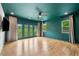 Spacious bedroom with hardwood floors, ceiling fan, and balcony doors at 32 Walthall Ne St # A, Atlanta, GA 30307