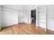 Bright walk-in closet with custom shelving and wood floors leading to bathroom at 32 Walthall Ne St # A, Atlanta, GA 30307