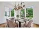 Bright dining room with large windows and contemporary lighting fixture over a table set for six at 32 Walthall Ne St # A, Atlanta, GA 30307