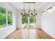 An empty room filled with natural light from large windows and a modern light fixture on the ceiling at 32 Walthall Ne St # A, Atlanta, GA 30307