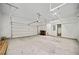 Spacious garage with ample overhead storage racks, an automatic door, and concrete floor at 32 Walthall Ne St # A, Atlanta, GA 30307