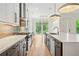 Modern kitchen with a gas cooktop, stainless steel appliances, and a large island with seating at 32 Walthall Ne St # A, Atlanta, GA 30307