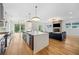 Open-concept kitchen flowing into the living room with stainless steel appliances and a large island at 32 Walthall Ne St # A, Atlanta, GA 30307