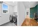Functional laundry room with modern machines, sleek cabinets, and stylish tiled floor at 32 Walthall Ne St # A, Atlanta, GA 30307