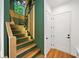 Modern staircase with wood steps, green walls, and decorative lighting at 32 Walthall Ne St # A, Atlanta, GA 30307