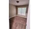 Cozy bedroom featuring neutral walls, plush carpet, and a window with natural light at 3645 Mcclaren Way, Lawrenceville, GA 30044