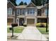 Inviting townhome with a well-maintained lawn, paved driveway, and an attached single-car garage at 3645 Mcclaren Way, Lawrenceville, GA 30044