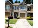 Charming townhome featuring a well-manicured lawn, paved driveway, and an attached single-car garage at 3645 Mcclaren Way, Lawrenceville, GA 30044