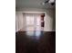 Open-concept living room with hardwood floors, seamlessly connecting to the dining area at 3645 Mcclaren Way, Lawrenceville, GA 30044