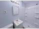 Clean bathroom with a white shower-tub, sleek vanity, and modern lighting fixture at 4103 Indian Creek Cir, Stone Mountain, GA 30083