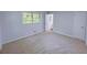 Neutral bedroom with plush carpeting, two windows, fresh paint, and a closet at 4103 Indian Creek Cir, Stone Mountain, GA 30083