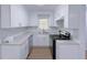 Modern kitchen with white cabinets, granite countertops, and stainless steel appliances at 4103 Indian Creek Cir, Stone Mountain, GA 30083