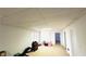 The basement features a drop ceiling, carpeted floor, a window and white walls at 4569 Campenille Trce, Suwanee, GA 30024