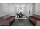 The dining room is lit by a modern light fixture, has sofas, and a dining table at 4569 Campenille Trce, Suwanee, GA 30024