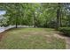 A large, grassy backyard is enclosed with a white picket fence and mature trees at 2177 Mauldin Nw St, Atlanta, GA 30318