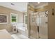 Bright bathroom featuring a separate shower, soaking tub, and ample natural light at 2177 Mauldin Nw St, Atlanta, GA 30318
