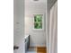 Bright bathroom with a window offering a view of lush greenery at 2177 Mauldin Nw St, Atlanta, GA 30318