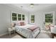 Inviting bedroom with two large windows, a comfortable bed, and neutral decor at 2177 Mauldin Nw St, Atlanta, GA 30318