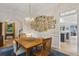 Well-lit dining room with a decorative lighting fixture and a display of Gathering photographs on the wall at 2177 Mauldin Nw St, Atlanta, GA 30318