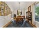 Elegant dining room featuring a stylish light fixture, wood floors, and ample natural light at 2177 Mauldin Nw St, Atlanta, GA 30318