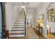 Welcoming foyer featuring staircase, hardwood floors, and abundant natural light at 2177 Mauldin Nw St, Atlanta, GA 30318