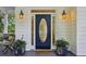 Elegant front door with decorative glass, flanked by potted plants, and stylish sconces, enhancing the entrance at 2177 Mauldin Nw St, Atlanta, GA 30318