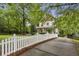 Charming two-story home with a white picket fence and lush landscaping, creating a welcoming curb appeal at 2177 Mauldin Nw St, Atlanta, GA 30318