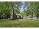 Charming home with a spacious front yard enclosed by a classic white picket fence and lush trees at 2177 Mauldin Nw St, Atlanta, GA 30318