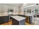 Open-concept kitchen with stainless steel appliances, an island, and views into an adjacent living area at 2177 Mauldin Nw St, Atlanta, GA 30318