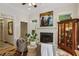 Living room with hardwood floors, a fireplace, neutral paint, built-in display cabinet, and large windows at 2177 Mauldin Nw St, Atlanta, GA 30318