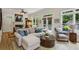 Comfortable living room with hardwood floors, neutral tones, French doors leading to a deck, and large windows at 2177 Mauldin Nw St, Atlanta, GA 30318
