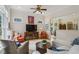 Open-concept living room with hardwood floors, bright windows, ceiling fan, and an eat-in kitchen nearby at 2177 Mauldin Nw St, Atlanta, GA 30318