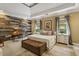 Charming main bedroom with a wood accent wall, tray ceilings, and plentiful natural light at 2177 Mauldin Nw St, Atlanta, GA 30318