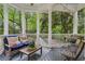 Inviting screened porch featuring comfortable seating, a cozy swing, and views of the surrounding greenery at 2177 Mauldin Nw St, Atlanta, GA 30318