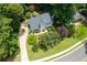 Aerial view of a well-maintained home with a lush green lawn and mature trees at 3511 Stone Cliff Way, Woodstock, GA 30189