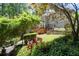 Spacious backyard with a multilevel wooden deck, stone steps, and meticulously landscaped yard at 3511 Stone Cliff Way, Woodstock, GA 30189
