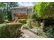 Multi-level backyard featuring lush landscaping, stone steps, and a spacious deck with access to the house at 3511 Stone Cliff Way, Woodstock, GA 30189