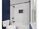 Neat bathroom with white tile tub surround and dark blue accent wall at 3511 Stone Cliff Way, Woodstock, GA 30189