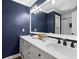 Modern bathroom features navy blue accents, white vanity, and decorative mirror at 3511 Stone Cliff Way, Woodstock, GA 30189