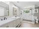 Modern bathroom with marble countertop, gray cabinets, and sleek glass enclosed shower at 3511 Stone Cliff Way, Woodstock, GA 30189