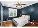 Comfortable bedroom with hardwood floors, painted walls, and bright natural light at 3511 Stone Cliff Way, Woodstock, GA 30189