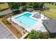 Community pool area with lounge chairs and umbrellas, surrounded by lush landscaping at 3511 Stone Cliff Way, Woodstock, GA 30189