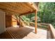 Spacious wooden deck with a staircase, perfect for outdoor dining and relaxation with views of wooded backyard at 3511 Stone Cliff Way, Woodstock, GA 30189
