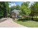 Home featuring a long drive, mature landscaping, and attached two-car garage at 3511 Stone Cliff Way, Woodstock, GA 30189